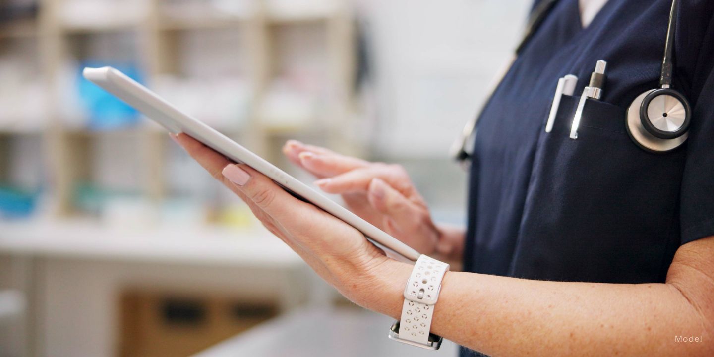 medical person holding a tablet in a surgical room
